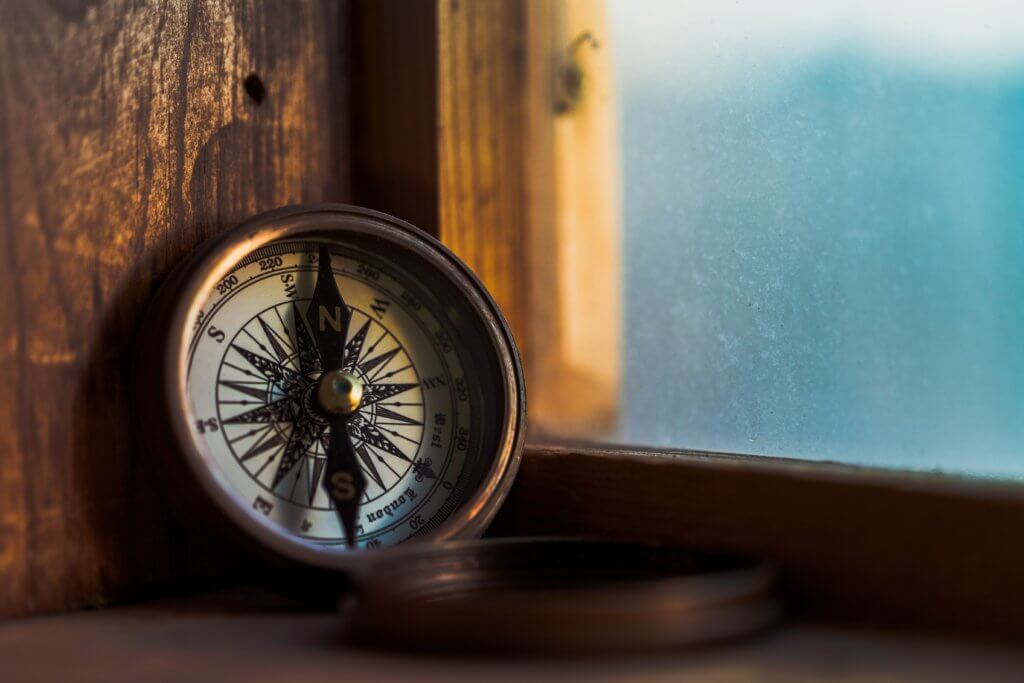 compass leaning against window